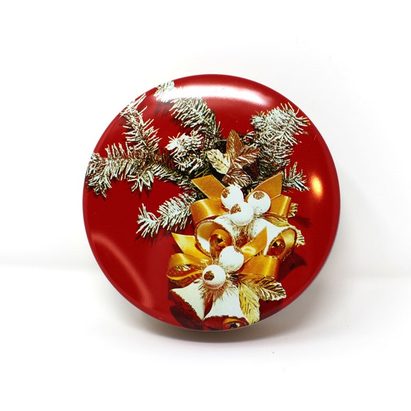 Small red holiday cookie or fruitcake (or buttons) tin; flocked pine branches, gold and white bells and ribbon