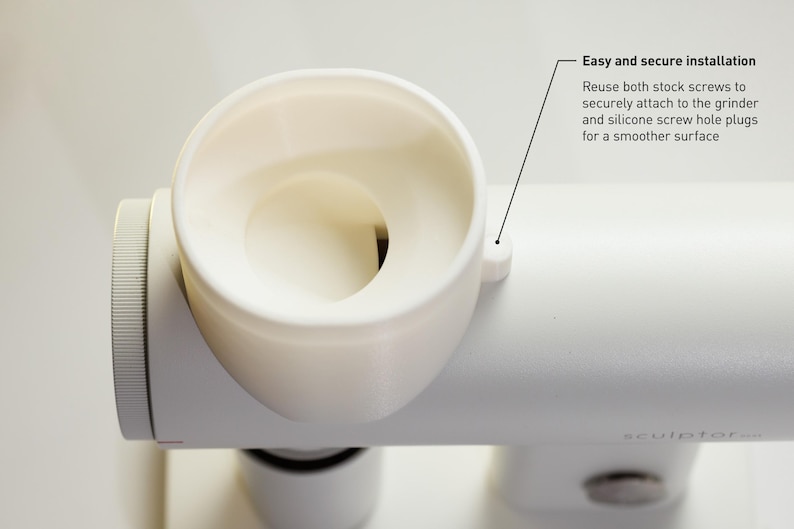 May include: A close-up of a white grinder component with a circular opening and a textured dial. The text "Easy and secure installation" is visible, along with instructions for attaching the grinder.