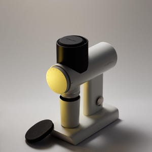 May include: A white and black device with a cylindrical body and a circular light. The device has a base and a small, black, circular object next to it. The text "NITROPRESS" is visible on the top.