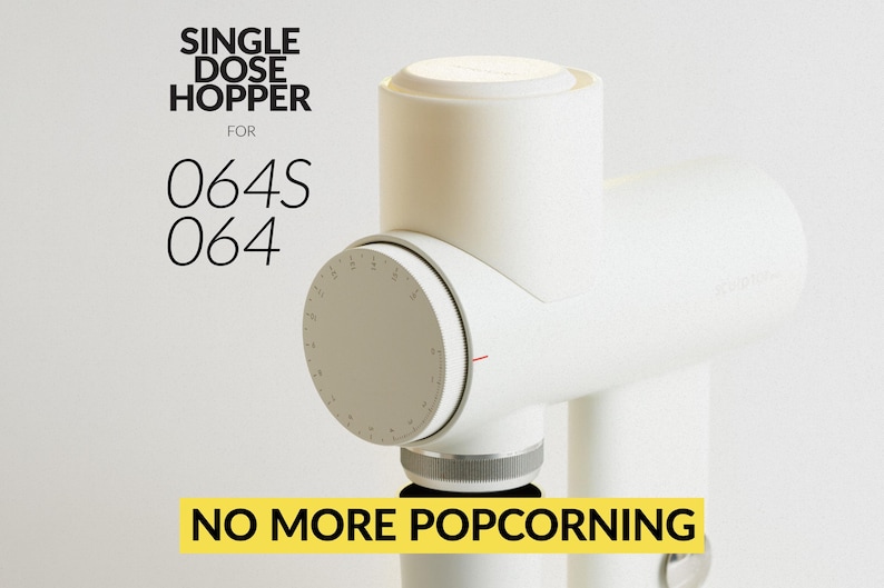 May include: A white single dose hopper for 064S 064 coffee grinders. The image shows a close-up of the hopper with a dial and the text "NO MORE POPCORNING" in a yellow box.