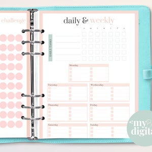 May include: A pink and white planner with a daily and weekly schedule. The planner has a section for daily tasks and a section for decluttering challenges. The planner is designed for use with a disc-bound system.