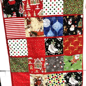 Peut inclure: Calendrier de l'Avent de Noël en tissu rouge avec 24 poches. Chaque poche présente un motif différent sur le thème des fêtes, notamment des pois, des maisons en pain d'épices et le Père Noël. Le calendrier a une poignée rouge en haut pour l'accrocher.