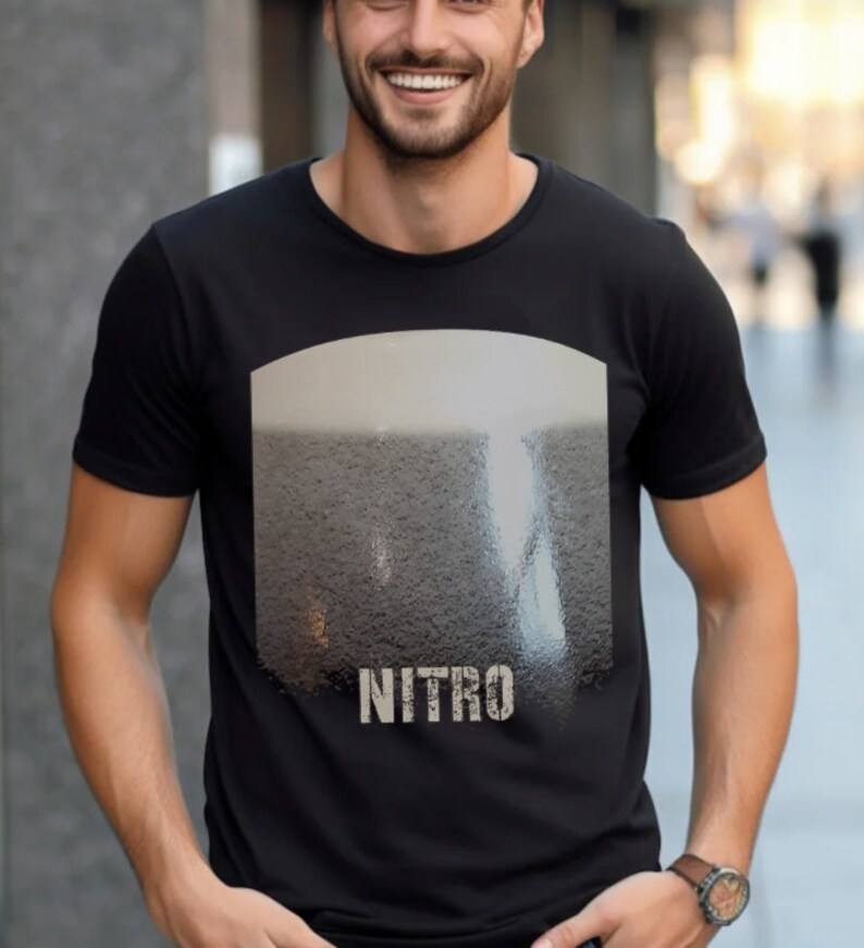 May include: Black t-shirt with a graphic of a glass of beer with the word "NITRO" printed below it.