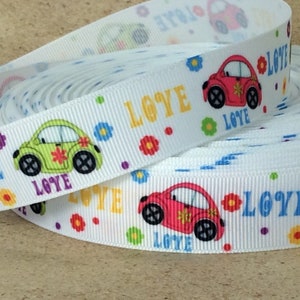 May include: White ribbon with a repeating pattern of colorful cars, flowers, and the word "LOVE".
