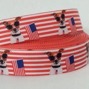 May include: Red, white, and blue ribbon with a repeating pattern of a dog wearing sunglasses and holding an American flag.