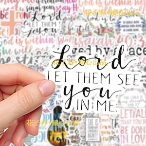 May include: A white die-cut sticker featuring the black text Lord LET THEM SEE you IN ME. The sticker is displayed against a background of various other religious-themed stickers with diverse fonts, floral patterns, and inspirational phrases.