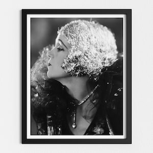 May include: Black and white portrait of a woman wearing a sparkling headpiece and a dark, lacy dress. She is looking up and to the side.