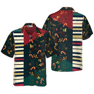 May include: A short-sleeved button-down shirt with a festive Christmas theme. The shirt features a patchwork design with candy canes, snowflakes, and Christmas trees. The color palette includes red, green, and gold, with a piano key pattern on the front.