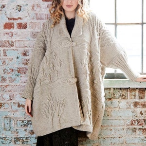 May include: A beige knitted cardigan with a cable knit pattern and button closure. The cardigan has a relaxed fit and long sleeves.