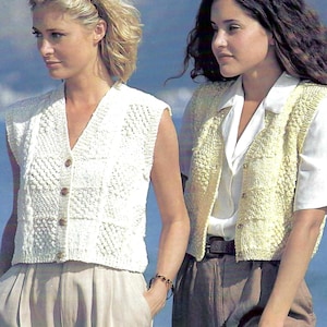 May include: Two sleeveless knitted vests. One is cream-colored with a V-neck and wooden buttons. The other is light yellow with a textured pattern and a V-neck. Both vests are worn over shirts and paired with neutral-colored pants.