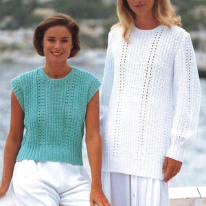 May include: Two knitted tops are shown. One is a short-sleeved, turquoise top with a ribbed hem. The other is a long-sleeved, white sweater with a crew neck. Both tops have a textured, open-knit design. The models are standing outdoors.