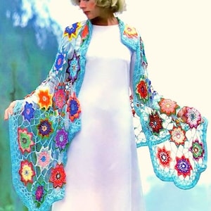 May include: A crocheted shawl with a floral design in shades of blue, pink, yellow, and green. The shawl is made of a lightweight yarn and has a delicate, lacy texture.