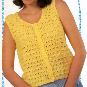 May include: A sleeveless, yellow knitted top with a V-neckline and button-up front. The top has a textured, open-weave design and is made of a soft, lightweight material. The buttons are the same yellow color as the top.