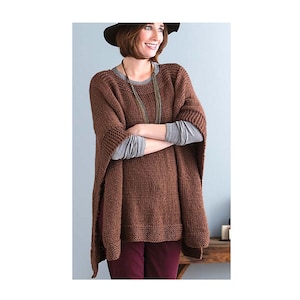 May include: A brown knitted poncho with a wide neckline and long sleeves. The poncho is being worn by a person with brown hair and a brown hat.