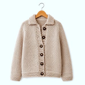 May include: A beige chunky knit cardigan featuring a collared neckline, long sleeves, and a front button closure with six dark brown circular buttons. The garment is displayed on a wooden hanger against a plain white background.