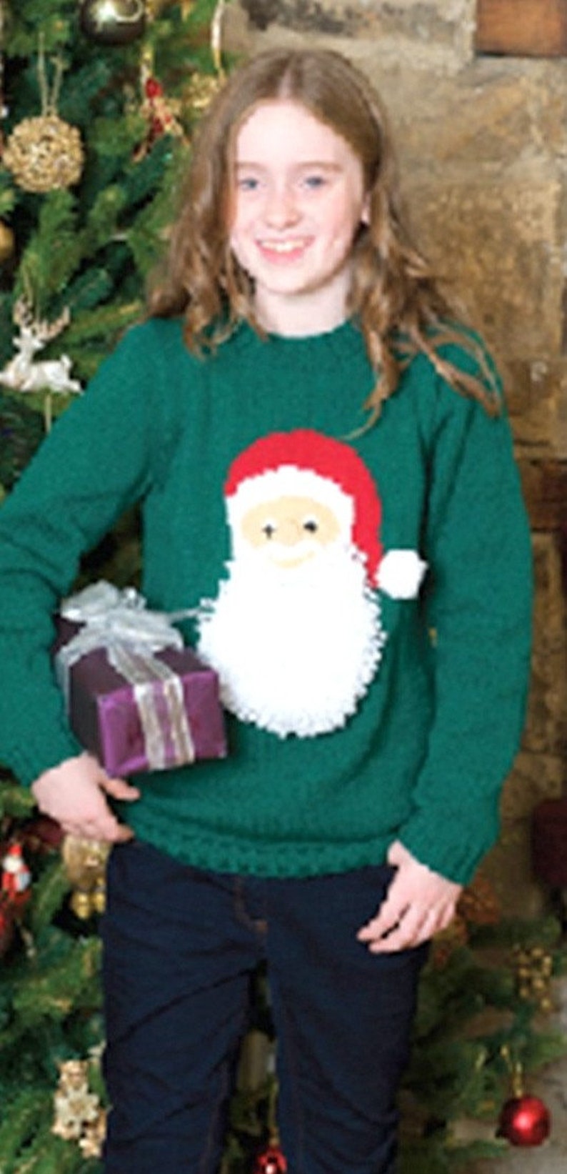 May include: A green knitted sweater with a white Santa Claus design. The sweater has a crew neck and long sleeves.