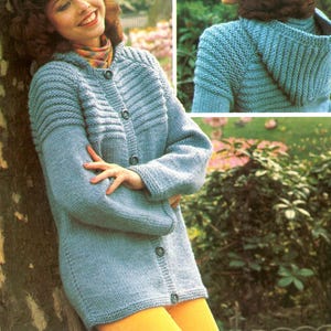 May include: A light blue knitted cardigan with a hood and button closure. The cardigan has a ribbed design on the upper chest and sleeves. The model is wearing yellow pants. The image is a vintage fashion illustration.