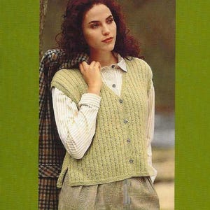 May include: A pale green knitted vest with a button-down front. The vest is worn over a white striped collared shirt and paired with a plaid skirt. A plaid jacket is draped over the shoulder.