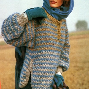 May include: A blue and brown striped knitted jumper with a single button fastening at the neck. The jumper has a relaxed fit and long sleeves.