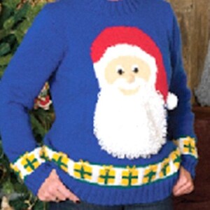 May include: A blue knitted sweater with a white, red, and beige Santa Claus design. The sweater has a yellow and green striped band around the bottom.