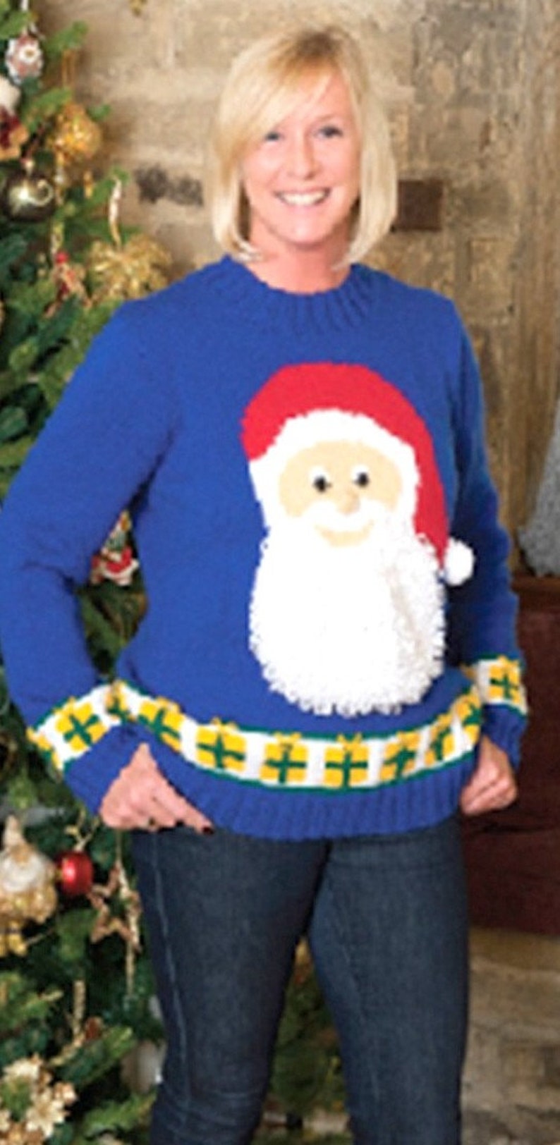 May include: A blue knitted sweater with a white, red, and beige Santa Claus design. The sweater has a yellow and green striped band around the bottom.