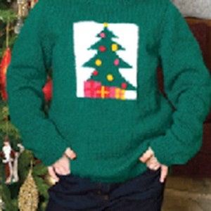 May include: A green knitted sweater with a white appliqu&eacute; of a Christmas tree with red and yellow ornaments. The sweater is worn by a person with red hair.