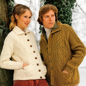 May include: A cream-coloured cable knit cardigan with a collar, long sleeves, and front buttons, alongside a mustard yellow cable knit cardigan featuring a collar, long sleeves, front buttons, and two patch pockets on the front.