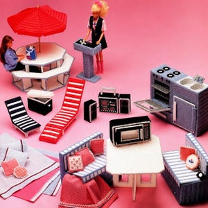 May include: A collection of miniature dollhouse furniture and accessories including a red umbrella table, a kitchen stove, a microwave, a boombox, lounge chairs, a dining set with pink cushions, and two dolls on a solid pink background.