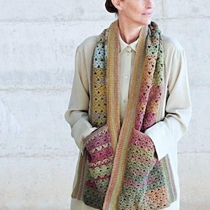 May include: A multi-colored crochet scarf with a pocket. The scarf is made with a variety of shades of brown, green, pink, and blue yarn.