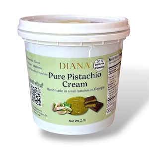 May include: A white plastic container of Diana Pure Pistachio Cream. The label features the text "Pure Pistachio Cream" and "Handmade in small batches in Georgia." The label also shows a picture of pistachios, cream, and chocolate. Net weight is 2 lb.