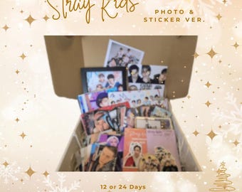 May include: An open box filled with Stray Kids Advent Calendar items. The box contains photos, stickers, prints, postcards, and pin badges. The text on the box reads "Stray Kids Advent Calendar Photo & Sticker Ver." and "12 or 24 Days".