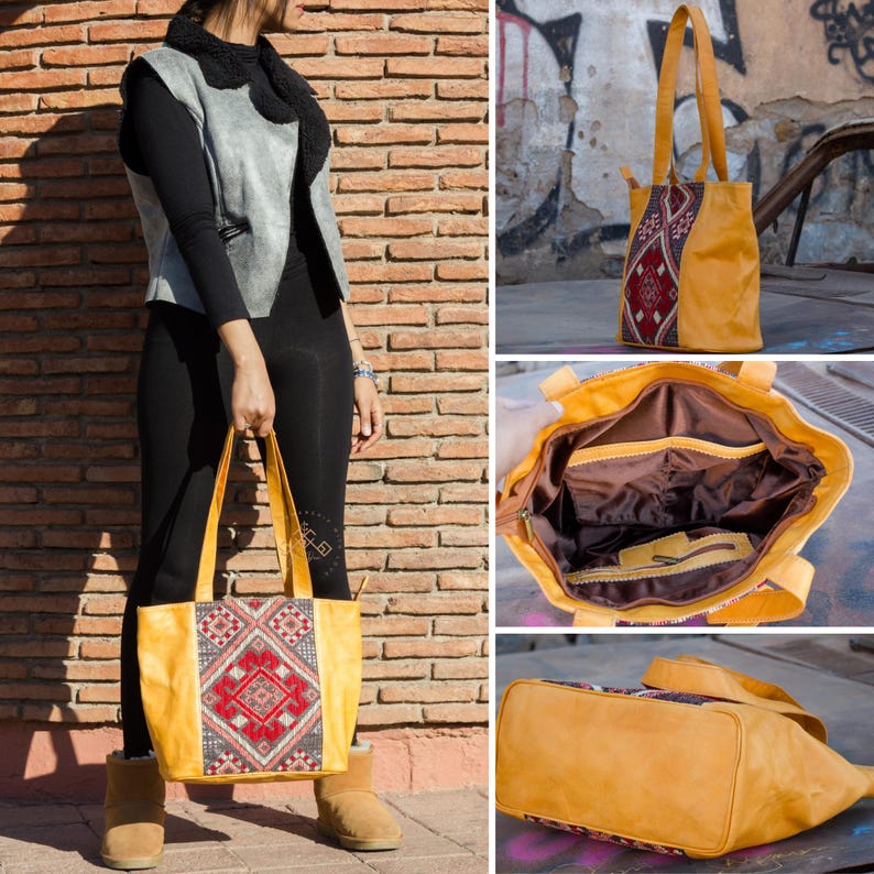 May include: A mustard yellow leather tote bag with a red, blue, and white geometric pattern. The bag has two top handles and a zipper closure.