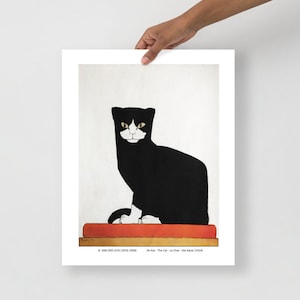 May include: A black and white cat with yellow eyes sits on a red book. The cat is looking directly at the viewer. The image is a vintage illustration by B. van der Leck, titled "De Kat - The Cat - Le Chat - Die Katze (1914)".