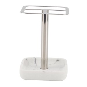 May include: A bathroom vanity organiser featuring a square white marble base with grey veining and a central vertical silver-toned metal post. The top consists of a square metal frame divided into four equal sections for holding various items.