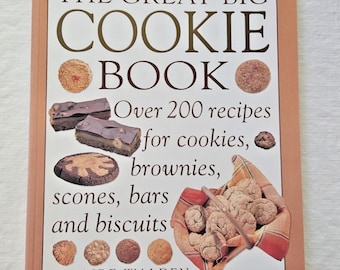 May include: A cookbook titled "THE GREAT BIG COOKIE BOOK" with a light brown cover. The cover features images of cookies, brownies, and scones. The book promises over 200 recipes for cookies, brownies, scones, bars, and biscuits.