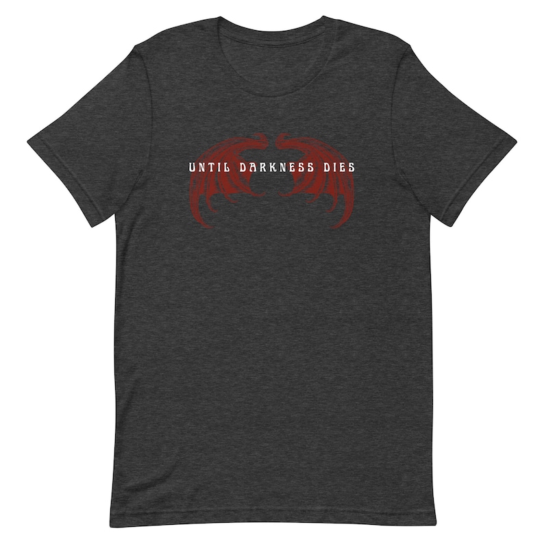 May include: Dark heather grey t-shirt with a red graphic of two wings and the text "Until Darkness Dies".