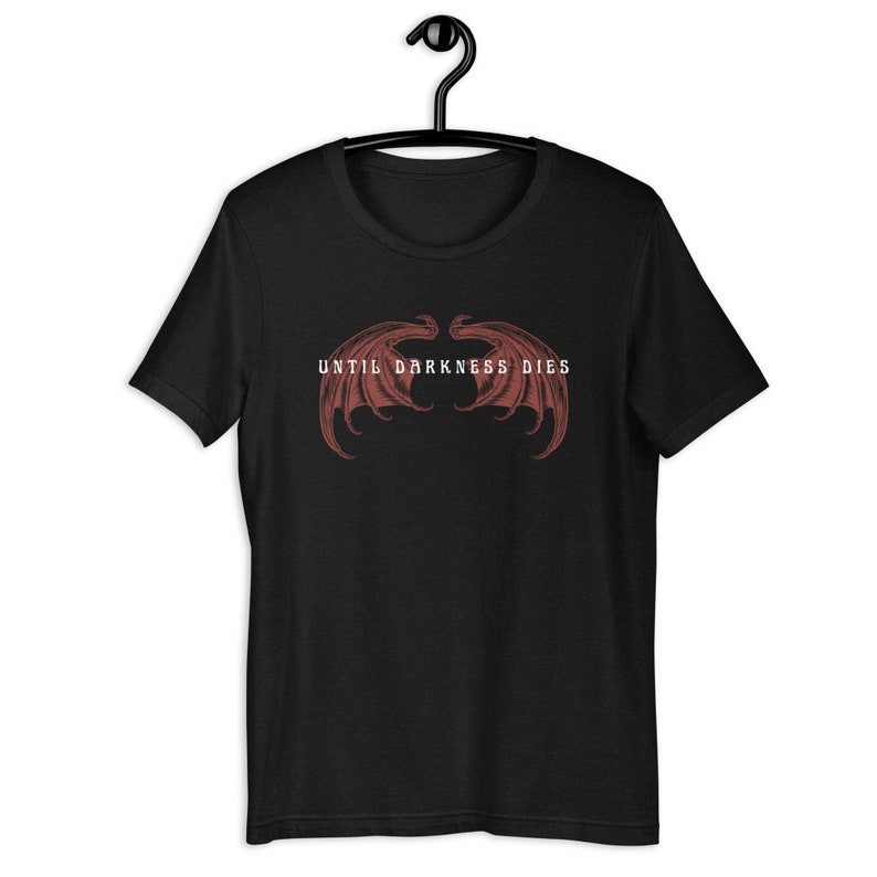 May include: Black t-shirt with a red graphic of a pair of wings and the text "UNTIL DARKNESS DIES" in white.