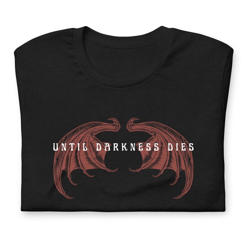 May include: Black t-shirt with a red graphic of two wings and the text "UNTIL DARKNESS DIES" in white.
