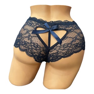 May include: Navy blue lace underwear with a heart-shaped cutout on the back. The underwear features a delicate floral lace pattern and a satin bow. The edges are scalloped.
