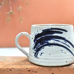 Hand thrown stoneware coffee mug with cobalt decoration.