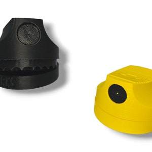 May include: Two spray paint caps, one black and one yellow. The black cap has a textured top and the yellow cap has a smooth top. Both caps have a small black hole in the center.