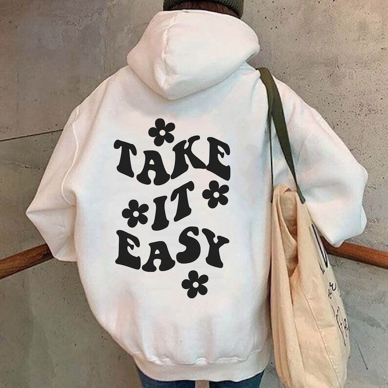 May include: White hooded sweatshirt with the text "TAKE IT EASY" in black with stylized flowers around the text.