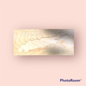 May include: A wooden cutout of Long Island, New York, with the words "New York Long Island" carved into the wood.