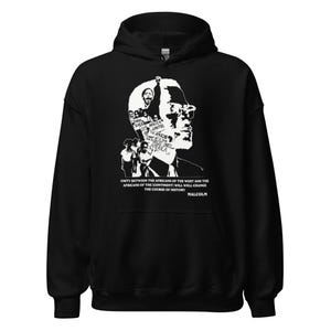 May include: Black and white graphic print hoodie featuring a silhouette of Malcolm X with text that reads "US Africa of the Rican Amenica" and "Unity between the Africans of the West and the Africans of the Continent will well change the course of history. Malcolm."