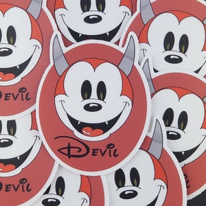 May include: Nine red and white circular stickers with a cartoon devil character with horns and a toothy grin. The stickers have the word "Devil" printed on them.