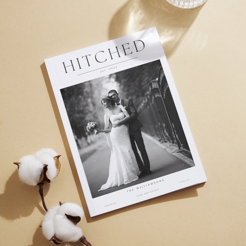 May include: A black and white wedding program with the title "HITCHED" and the date "EST. 2023". The program features a photo of a bride and groom in black and white. The text "THE WILLIAMSONS" is at the bottom of the page.