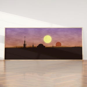 May include: A framed landscape art print featuring a silhouetted cityscape under a sunset sky. The artwork showcases two suns, one yellow and one orange, with a purple and orange gradient sky. The print is in a wooden frame.