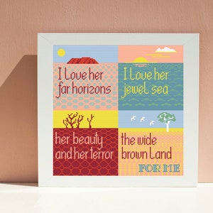 May include: A framed cross-stitch artwork with a colourful patchwork design. The artwork features a landscape with a red rock formation, a blue sea, and a yellow desert. The text reads "I love her far horizons, I love her jewel sea, her beauty and her terror, the wide brown land for me."