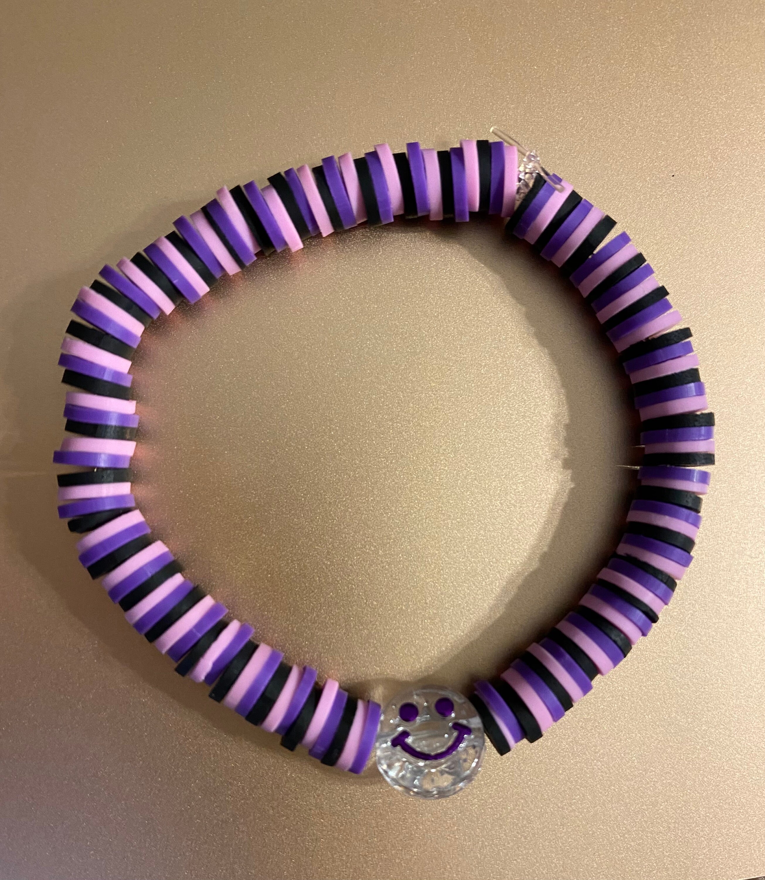 clay beads bracelets. one is purple with a flower - Depop