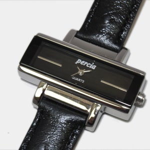Black rectangular watch, black ostrich grain strap
